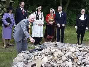 David laying the stone on cairn during Isle of Man's Tynwald ceremony, watched not only by the Speaker of the Manx House of Keys, the Hon James Brown but also by Thorbjorn Jagland, the Norwegian Labour MP and former President of the Norwegian legislature - the Storting -with his wife in national costume. Also watching in national costume is Ms Solveig Petursdottir, President of the Icelandic Parliament, the Althingi.