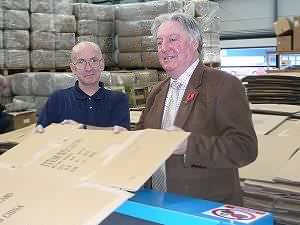 Eric at C2 Enterprises, Port Road, Carlisle, feeding corrugated cardboard into the shredding machine