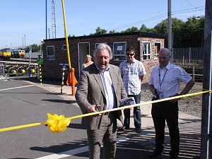 Eric cuts the ribbon