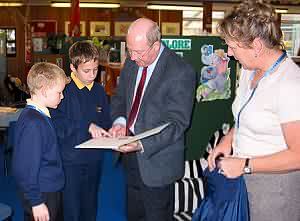 Liam and Karl show David their work, with Mrs Lowrie.