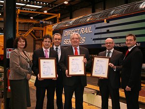 Eric, centre, with DRS staff and their new accreditation certificates