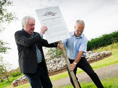 Eric and Russell return the sign